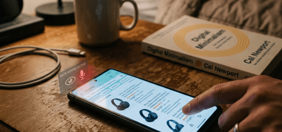 Hand using smartphone to browse headphones online with digital data mining alert