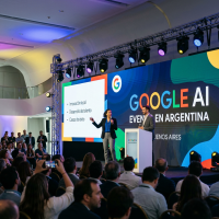 Two speakers on stage presenting at Google AI event in Buenos Aires with audience
