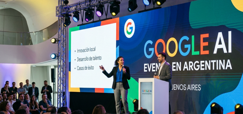 Two speakers on stage presenting at Google AI event in Buenos Aires with audience